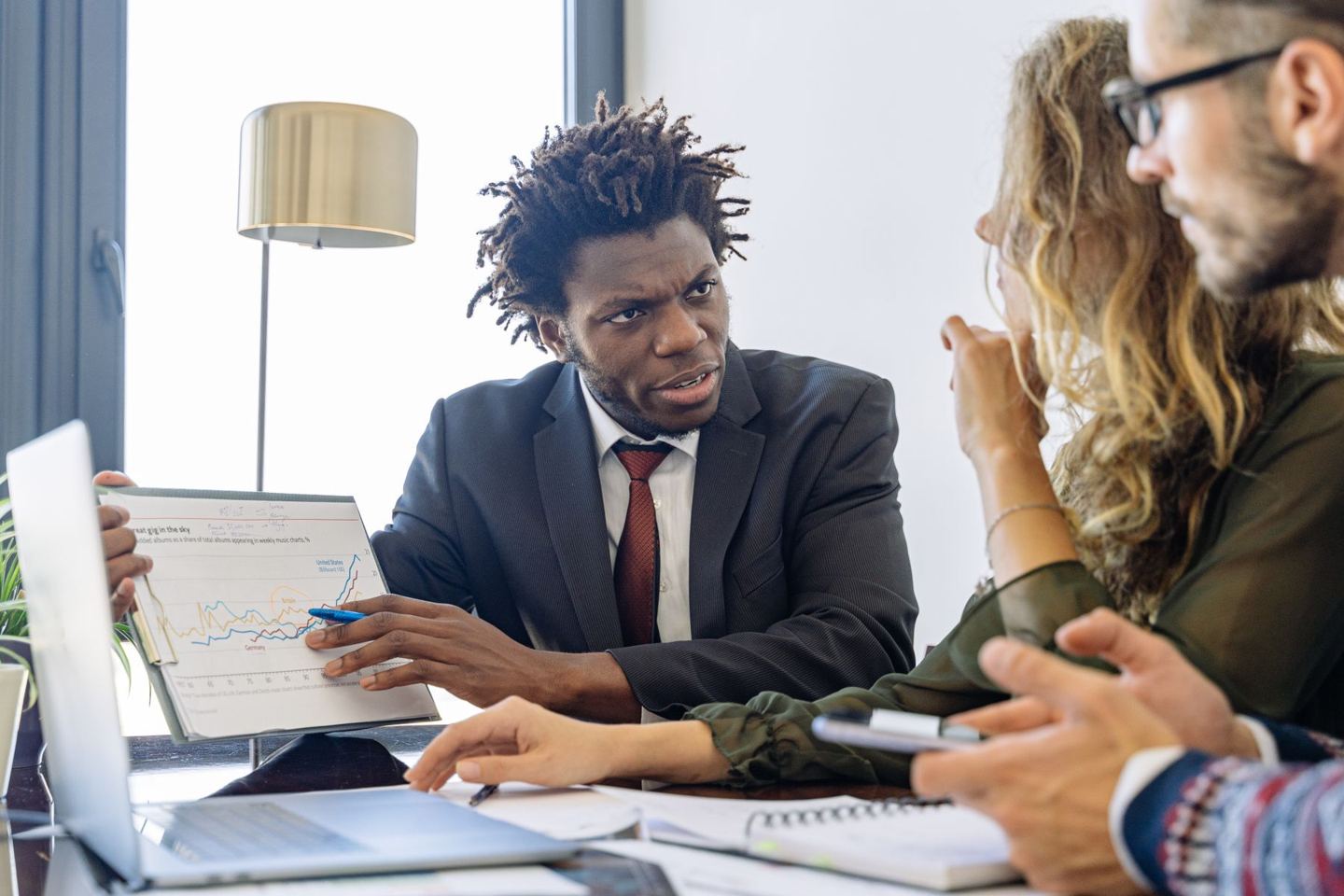 Financial professional presenting market data to clients