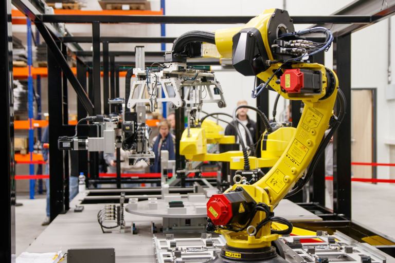Industrial robot arm operating in a manufacturing facility
