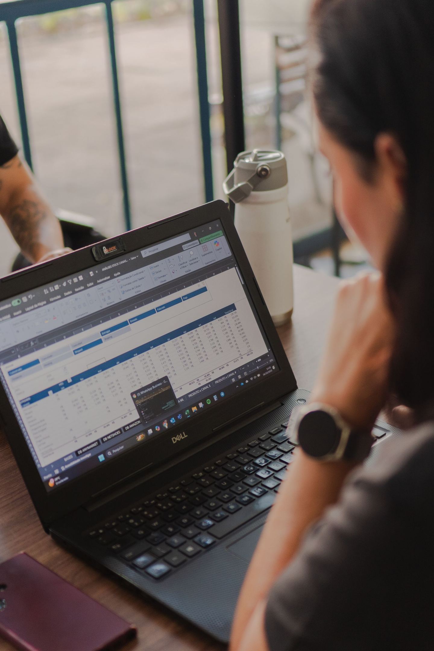Analyst reviewing data in a financial model on a laptop