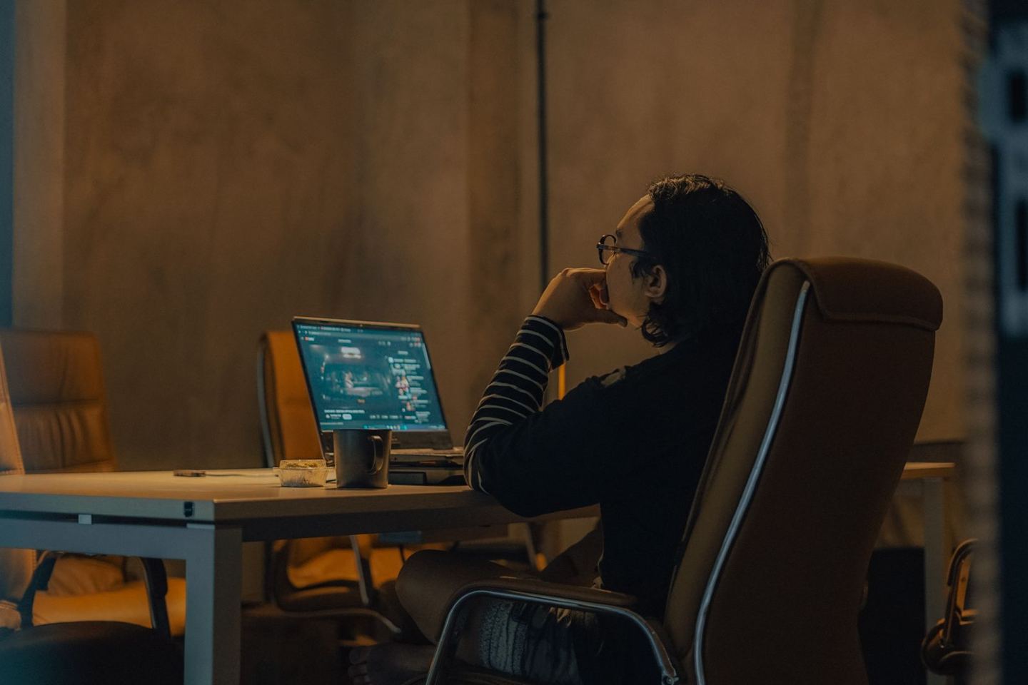 An analyst reviewing market data at a screen in a quiet office